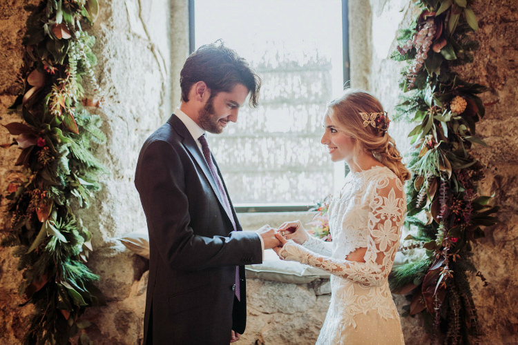 Bride Lace Backless Bridal Gown Intricate Autumn Leaves Headpiece Groom Charcoal Suit Purple Patterned Tie Window Florals Greenery From Dawn To Eternity Autumnal Wedding Ideas http://www.nataliaibarra.com
