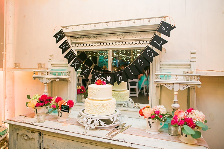Reception Vintage Dresser Handwritten Bunting Wedding Cake Bright Multicoloured Flowers LOVE Cups Flower Farm Outdoor Wedding Minnesota http://eileenkphoto.com/
