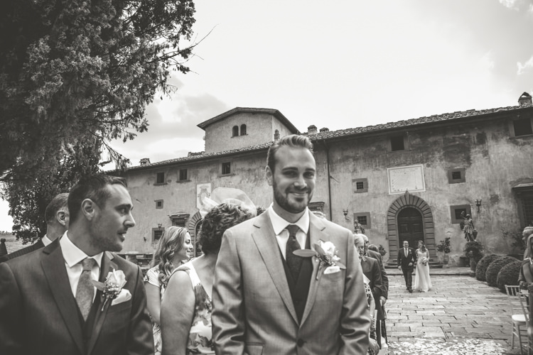 Outdoor Ceremony Groom Light Blue Suit Rose Buttonhole Groomsmen Guests Bride Father Entrance Historic Pink Villa Romantic Intimate Tuscany Destination Wedding http://angelicabraccini.com/