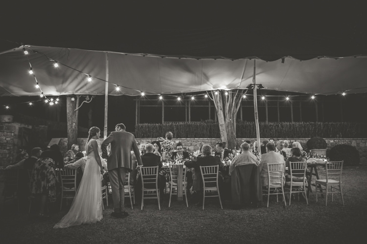 Marquee Reception Bride Lace Tulle Stella York Bridal Gown Groom Light Blue Suit Guests Fairy Lights Romantic Intimate Tuscany Destination Wedding http://angelicabraccini.com/