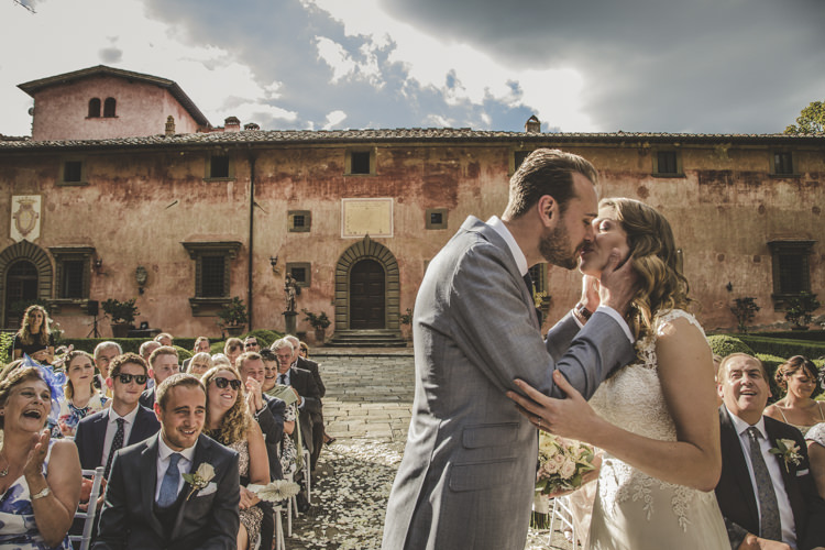 Outdoor Ceremony Bride Lace Tulle Stella York Bridal Gown Groom Light Blue Suit White Shirt Textured Blue Tie Guests Historic Pink Villa Romantic Intimate Tuscany Destination Wedding http://angelicabraccini.com/