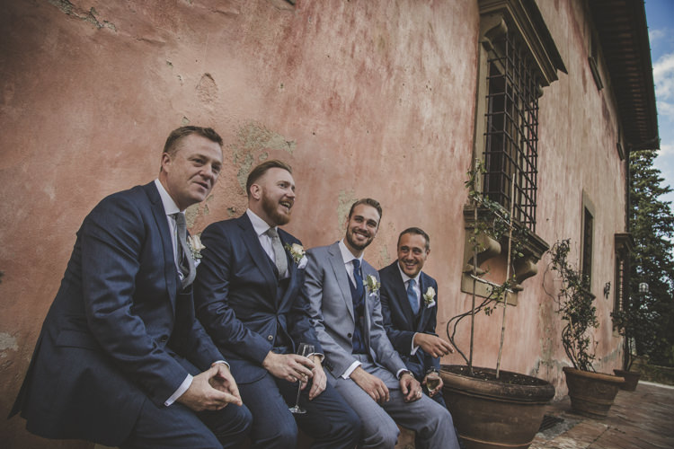 Groom Light Blue Suit White Shirt Textured Blue Tie Rose Buttonhole Groomsmen Dark Blue Suit Blue Ties Historic Pink Villa Romantic Intimate Tuscany Destination Wedding http://angelicabraccini.com/