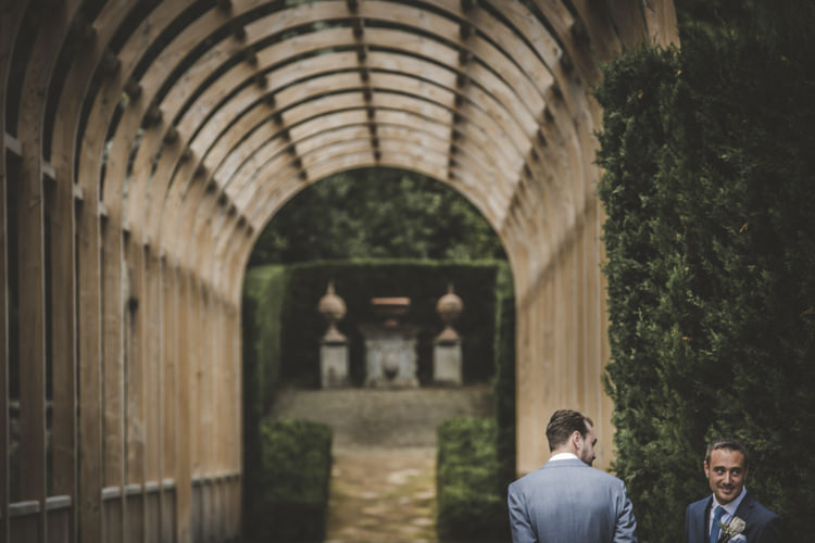 Outdoor Ceremony Groom Light Blue Suit Groomsman Archway Green Hedges Romantic Intimate Tuscany Destination Wedding http://angelicabraccini.com/