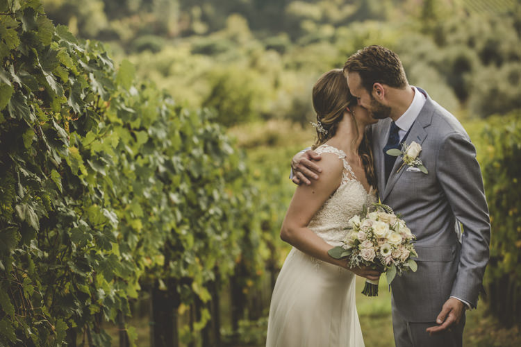 Bride Lace Tulle Stella York Bridal Gown Bouquet White Pink Roses Groom Light Blue Suit White Shirt Textured Blue Tie Rose Buttonhole Vineyard Romantic Intimate Tuscany Destination Wedding http://angelicabraccini.com/