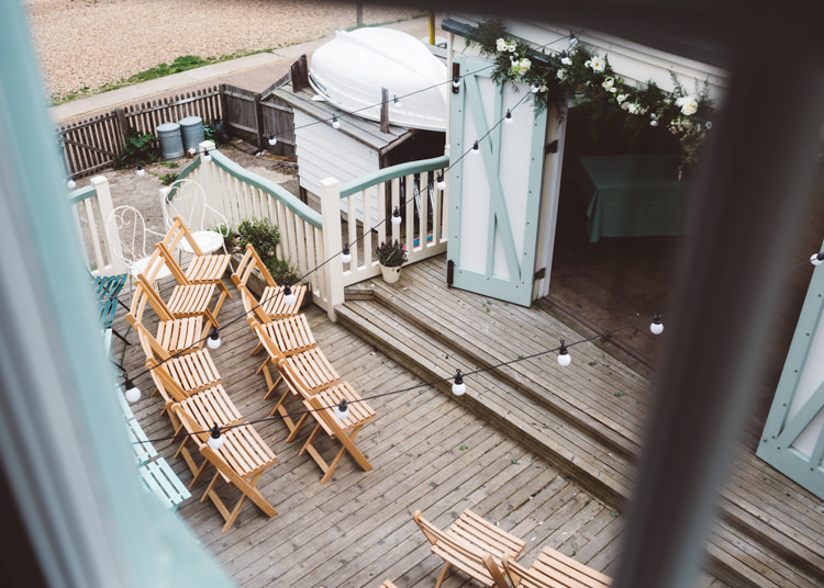 Outdoor Ceremony Festoon Lights Low Key Pastel Seaside Wedding http://holliecarlinphotography.com/