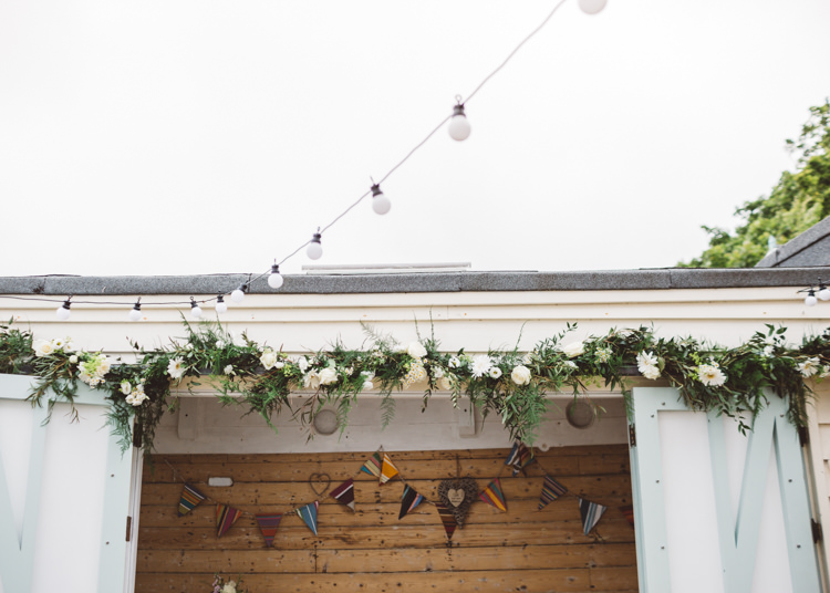 Flower Foliage Greenery Arch Ceremony Backdrop Low Key Pastel Seaside Wedding http://holliecarlinphotography.com/