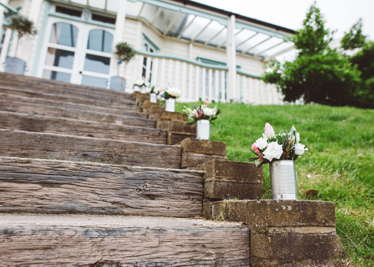 Tin Can Flowers Stairs Steps Low Key Pastel Seaside Wedding http://holliecarlinphotography.com/