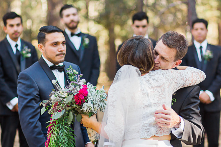 Outdoor Ceremony Bride Watters Separates Lace Top Tulle Skirt Veil Cascading Multicoloured Bouquet Father Groom Dark Blue Jacket Black Satin Lapel Black Bowtie Groomsmen Black Suits Black Bowties Ties DIY Whimsical Camp Wedding California http://www.landbphotography.org/