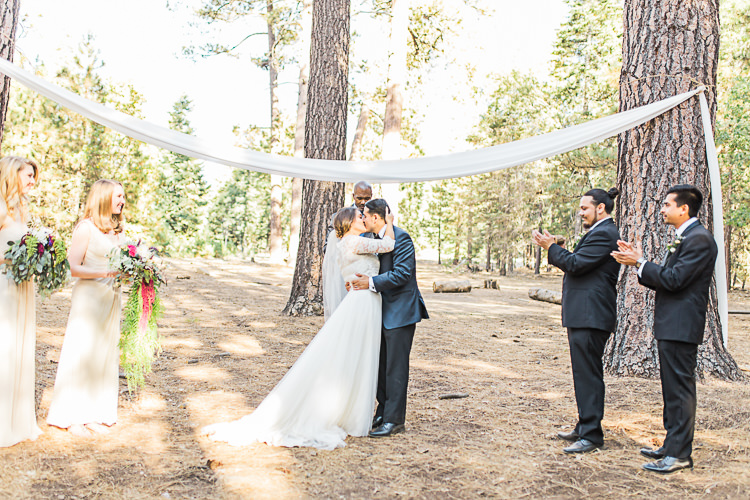Outdoor Ceremony Bride Watters Separates Lace Top Tulle Skirt Veil Cascading Multicoloured Bouquet Groom Dark Blue Jacket Black Satin Lapel Black Pants Bowtie Groomsmen Black Suits Bridesmaids Ivory Dresses Celebrant DIY Whimsical Camp Wedding California http://www.landbphotography.org/