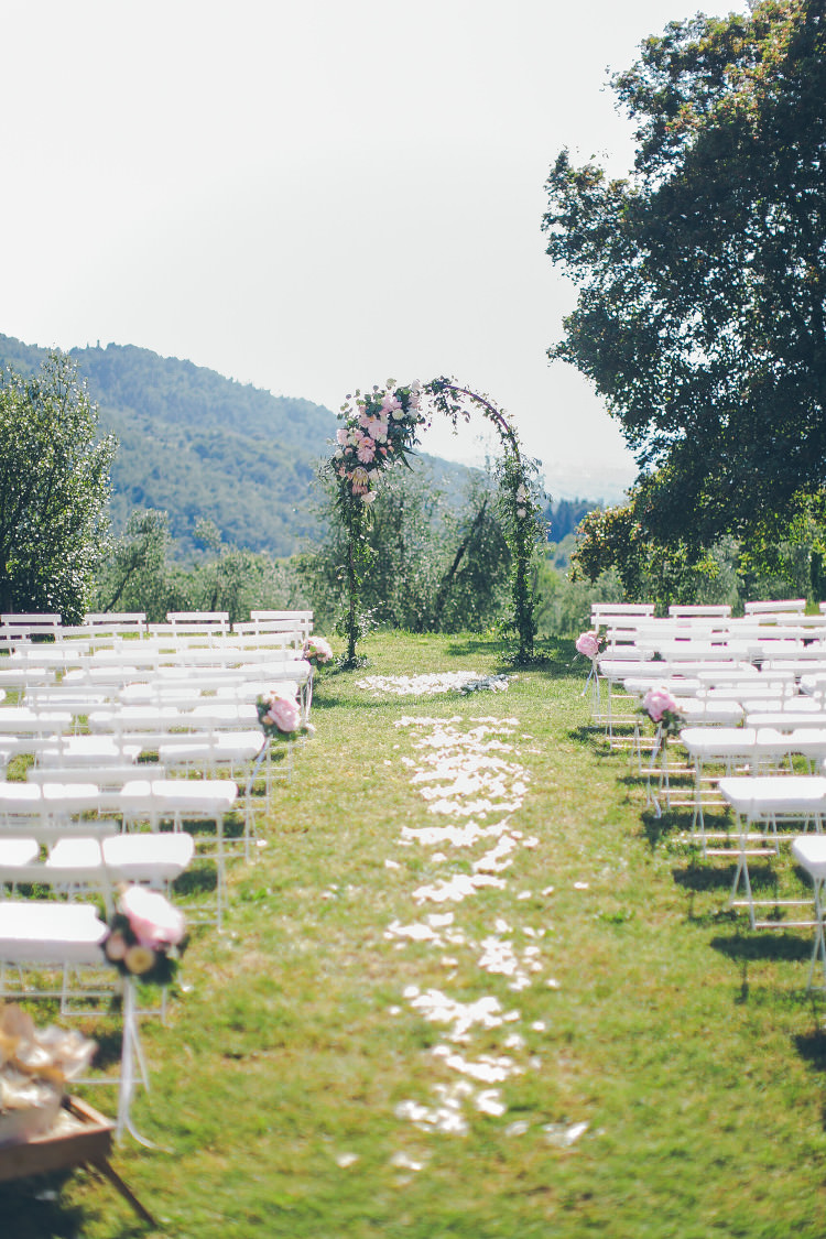 Outdoor Ceremony Floral Arch White Chairs Pink Flowers White Petals Beautiful Pink Blue Tuscany Villa Wedding http://www.chloemurdochphotography.com/