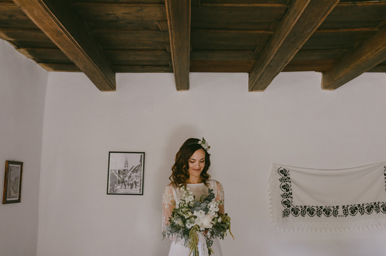 Bride Two Piece Lace Bridal Gown Floral Hairpiece Bouquet White Florals Roses Greenery Loose Curls Hairstyle Natural Greenery Stylish Wedding Transylvania https://raresion.com/