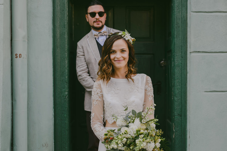 Bride Two Piece Lace Bridal Gown Floral Hairpiece Groom Light Blue Shirt Sand Jacket Dark Grey Vest Brown Pants Patterned Bowtie Sunglasses Natural Greenery Stylish Wedding Transylvania https://raresion.com/