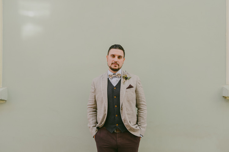 Groom Light Blue Shirt Sand Jacket Dark Grey Vest Brown Pants Patterned Bowtie Floral Buttonhole Natural Greenery Stylish Wedding Transylvania https://raresion.com/