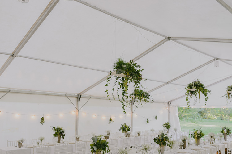 Reception White Marquee Hanging Greenery Lights Centrepieces Floral Fruit Arrangements White Chairs Natural Greenery Stylish Wedding Transylvania https://raresion.com/