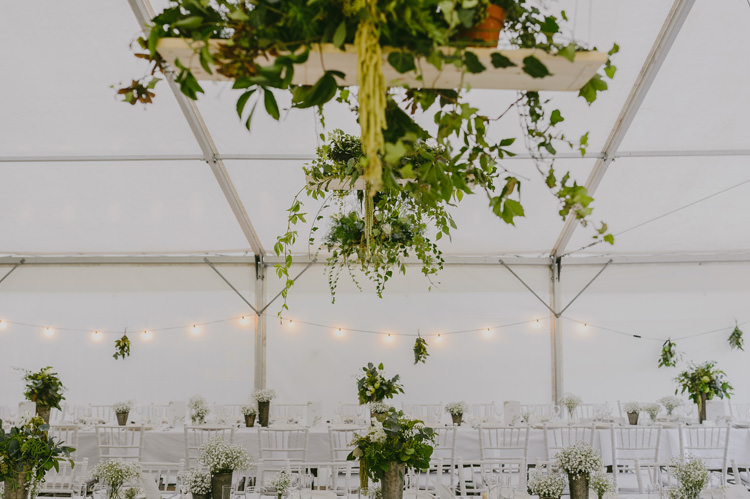 Reception Marquee White Chairs Hanging Lights Florals Greenery Natural Greenery Stylish Wedding Transylvania https://raresion.com/