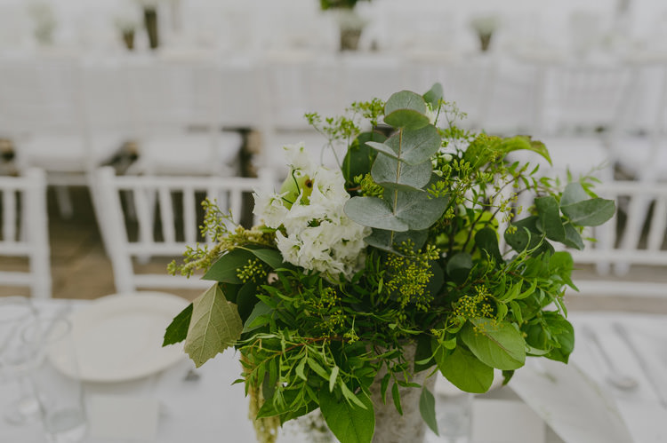 Reception Centrepiece White Floral Greenery Fruit Arrangement Silver Vase White Chairs Natural Greenery Stylish Wedding Transylvania https://raresion.com/
