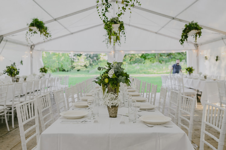 Reception White Marquee Hanging Décor Greenery Centrepieces White Floral Greenery Fruit Arrangement Silver Vase White Chairs Lights Natural Greenery Stylish Wedding Transylvania https://raresion.com/