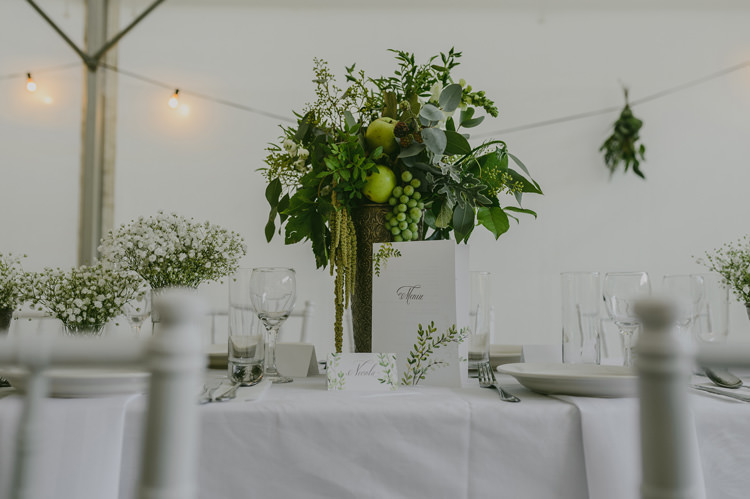Reception Table Setting White Tablecloth Centrepiece White Floral Greenery Fruit Arrangement Silver Vase Potted White Florals Hanging Lights Natural Greenery Stylish Wedding Transylvania https://raresion.com/