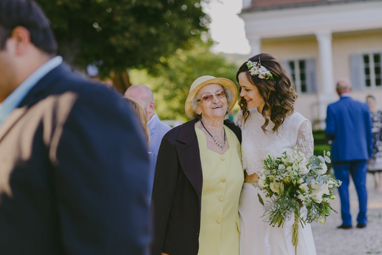 Bride Two Piece Lace Bridal Gown Floral Hairpiece Bouquet White Florals Greenery White Ribbon Guests Natural Greenery Stylish Wedding Transylvania https://raresion.com/