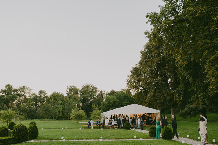 Reception White Marquee Guests Trees Natural Greenery Stylish Wedding Transylvania https://raresion.com/