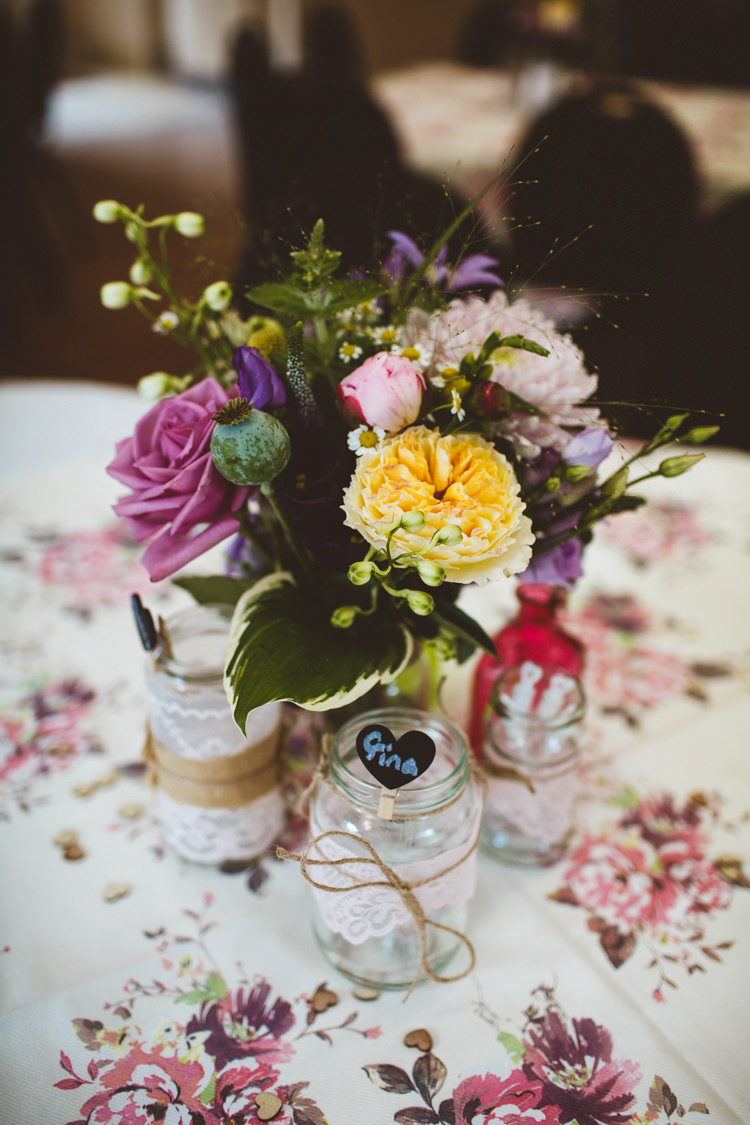 Table Flowers Centrepiece Decor Pink Yellow Lace Twine Jars Floral Table Cloth Runner Pretty DIY Outdoor Village Hall Wedding https://photography34.co.uk/