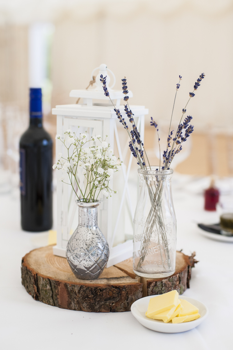 Centrepiece Log Lantern Candle Bottle Flowers Whimsical Summery Lilac Wedding http://eleanorjaneweddings.co.uk/