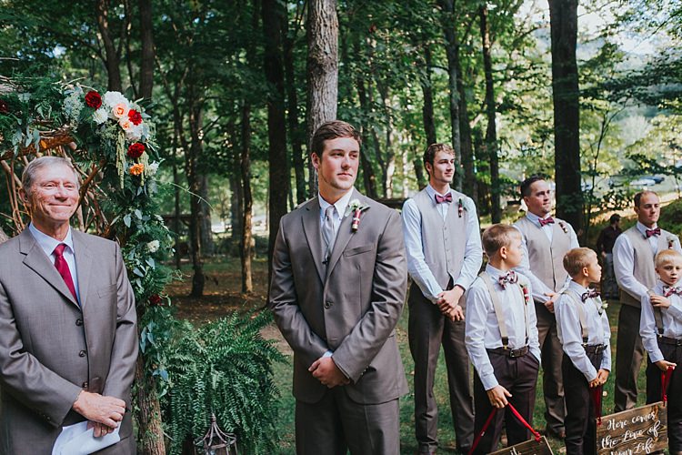 Outdoor Ceremony Groom Grey Suit White Shirt Light Grey Tie Vest Celebrant Groomsmen White Shirt Light Grey Vest Maroon Bowties Floral Arch Bohemian & Whimsical Garden Wedding in North Carolina http://www.taylorparkerphotography.com/