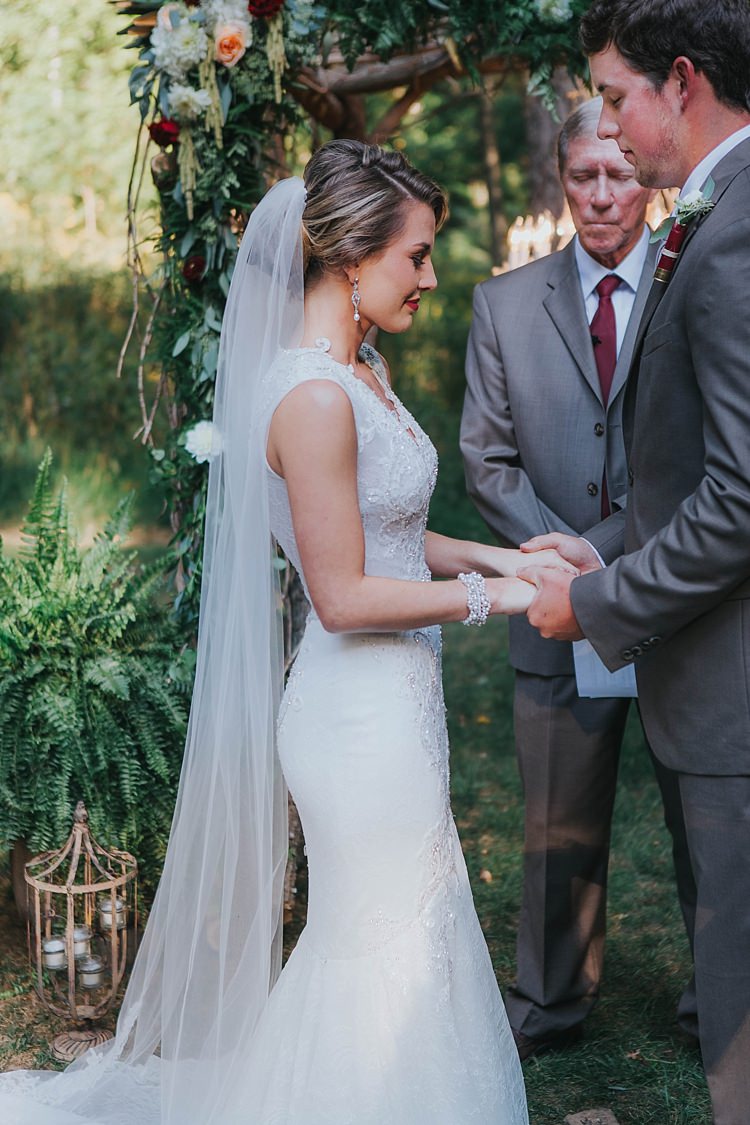 Outdoor Ceremony Floral Arch Bride V Neck Lace Embellished Gown Long Veil Groom Grey Suit White Shirt Floral Buttonhole Celebrant Bohemian & Whimsical Garden Wedding in North Carolina http://www.taylorparkerphotography.com/