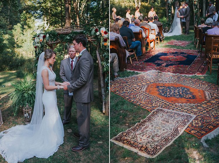 Outdoor Ceremony Floral Arch Bride V Neck Lace Embellished Gown Long Veil Groom Grey Suit White Shirt Floral Buttonhole Celebrant Bright Rugs Aisle Guests Wooden Chairs Bohemian & Whimsical Garden Wedding in North Carolina http://www.taylorparkerphotography.com/