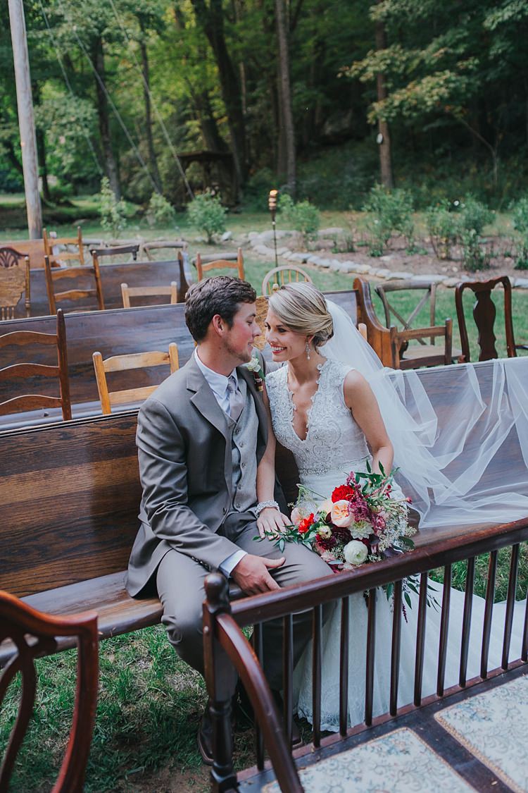 Bride V Neck Lace Embellished Bridal Gown Long Veil Multicoloured Bouquet Groom Grey Suit White Shirt Light Grey Tie Vest Mismatched Wooden Chairs Pews Bohemian & Whimsical Garden Wedding in North Carolina http://www.taylorparkerphotography.com/