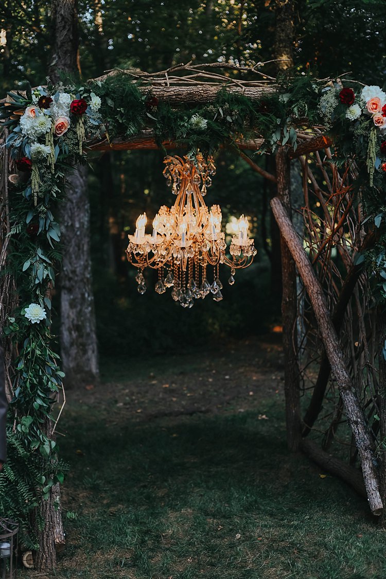 Outdoor Ceremony Wooden Floral Arch Multicoloured Flowers Greenery Chandelier Bohemian & Whimsical Garden Wedding in North Carolina http://www.taylorparkerphotography.com/