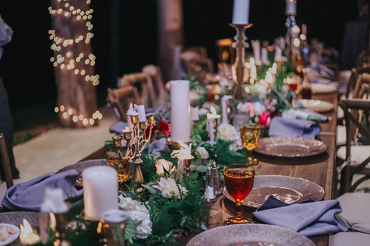 Reception Table Setting Bright Multicoloured Florals Greenery Gold Candlesticks Metallic Plates Wine Goblets Fairy Lights Bohemian & Whimsical Garden Wedding in North Carolina http://www.taylorparkerphotography.com/