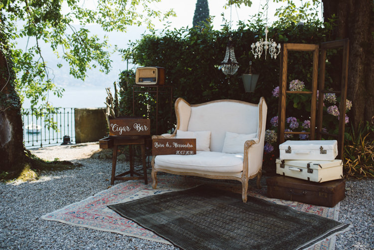 Cigar Bar Vintage Cream Couch Wooden Personalised Signs White Calligraphy Chandeliers Suitcases Rugs Botanical Copper Greenery Lake Como Wedding http://margheritacalatiphotography.com/