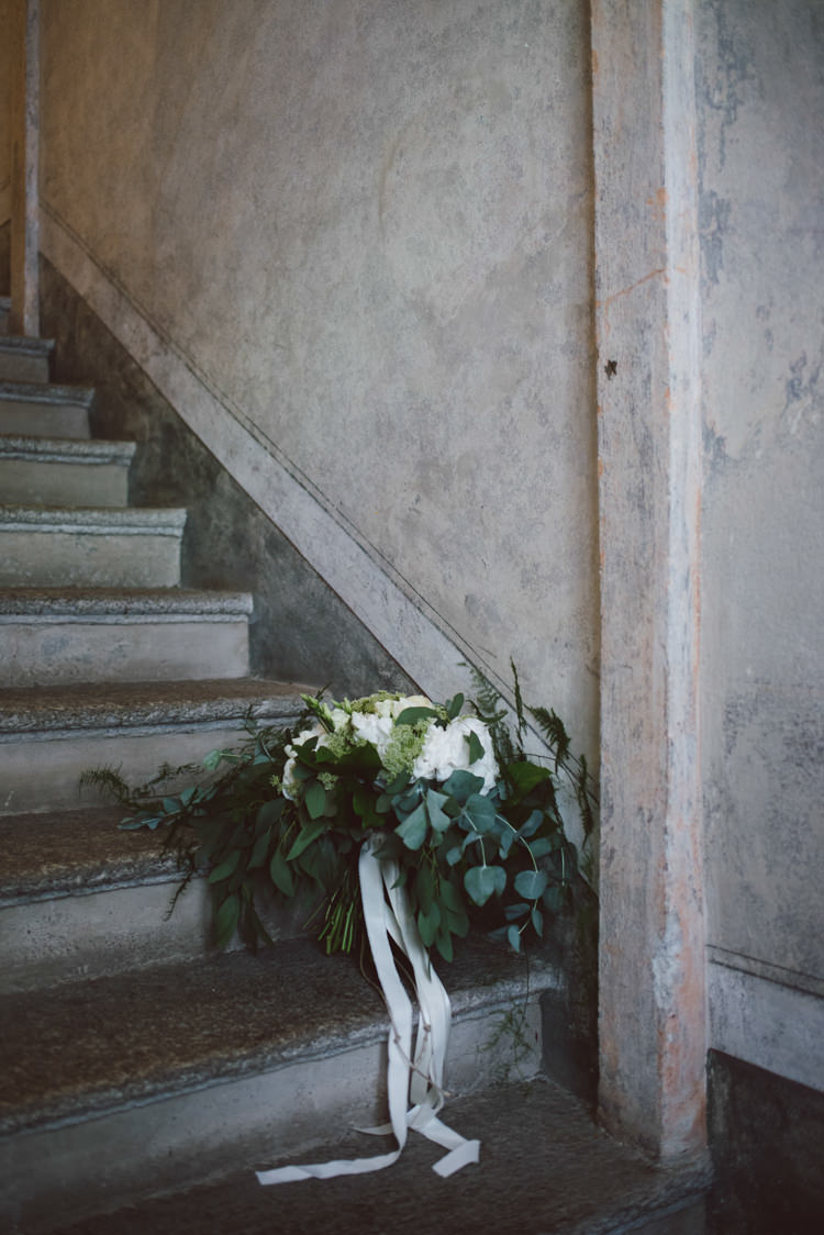 Bride Bouquet White Cream Florals Roses Greenery Eucalyptus Long White Ribbon Botanical Copper Greenery Lake Como Wedding http://margheritacalatiphotography.com/