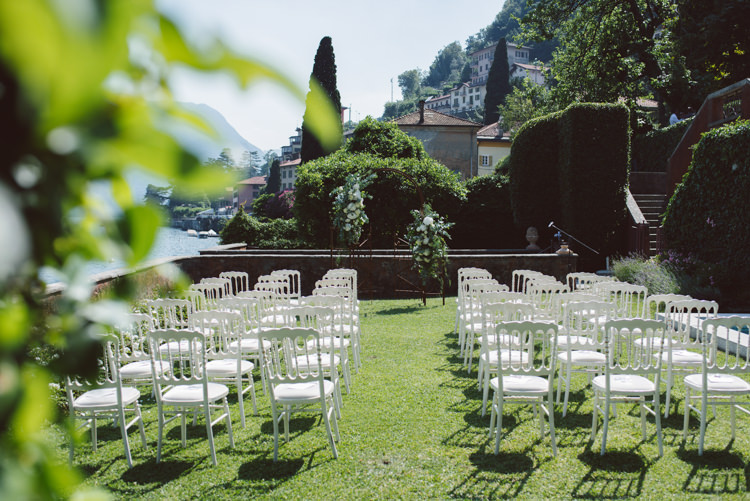 Outdoor Ceremony Rusted Arch White Cream Florals Greenery White Chairs Grass Lake View Botanical Copper Greenery Lake Como Wedding http://margheritacalatiphotography.com/