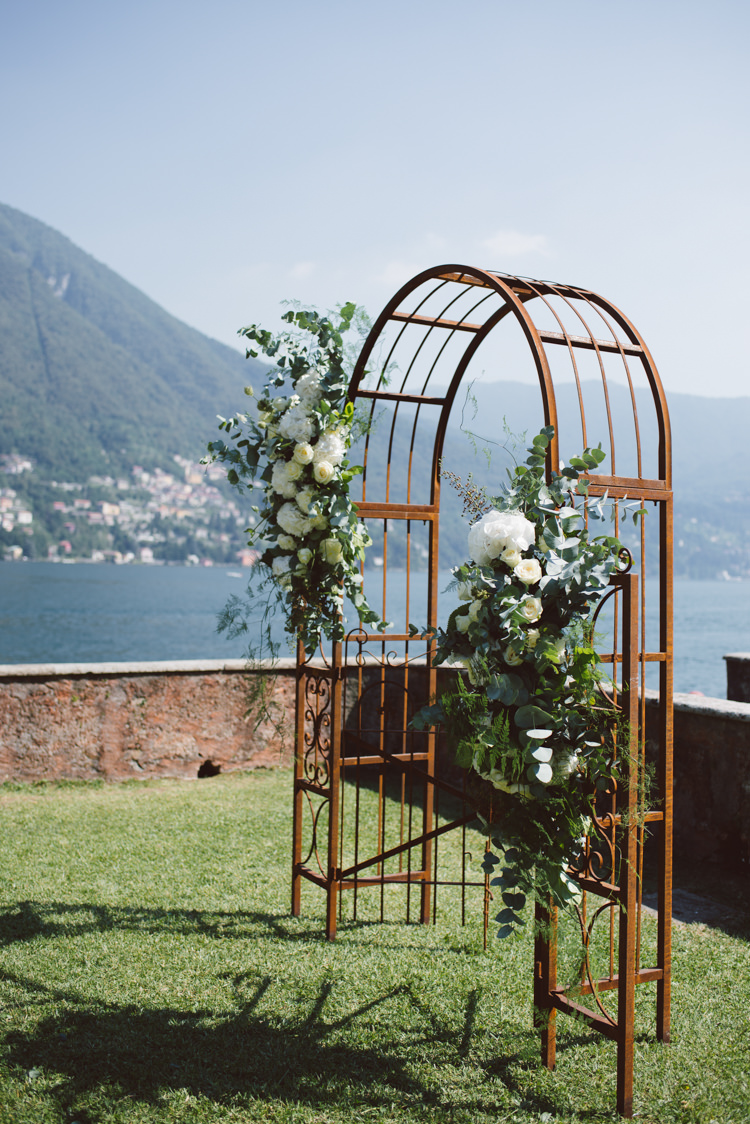 Outdoor Ceremony Rusted Arch White Cream Florals Roses Greenery Eucalyptus Grass Lake View Botanical Copper Greenery Lake Como Wedding http://margheritacalatiphotography.com/