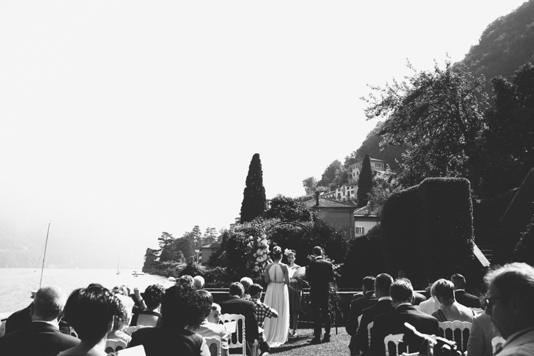 Outdoor Ceremony Bride V Neck Jenny Packham Embellished Bridal Gown Groom Tailored Black Suit Guests Lake View Botanical Copper Greenery Lake Como Wedding http://margheritacalatiphotography.com/