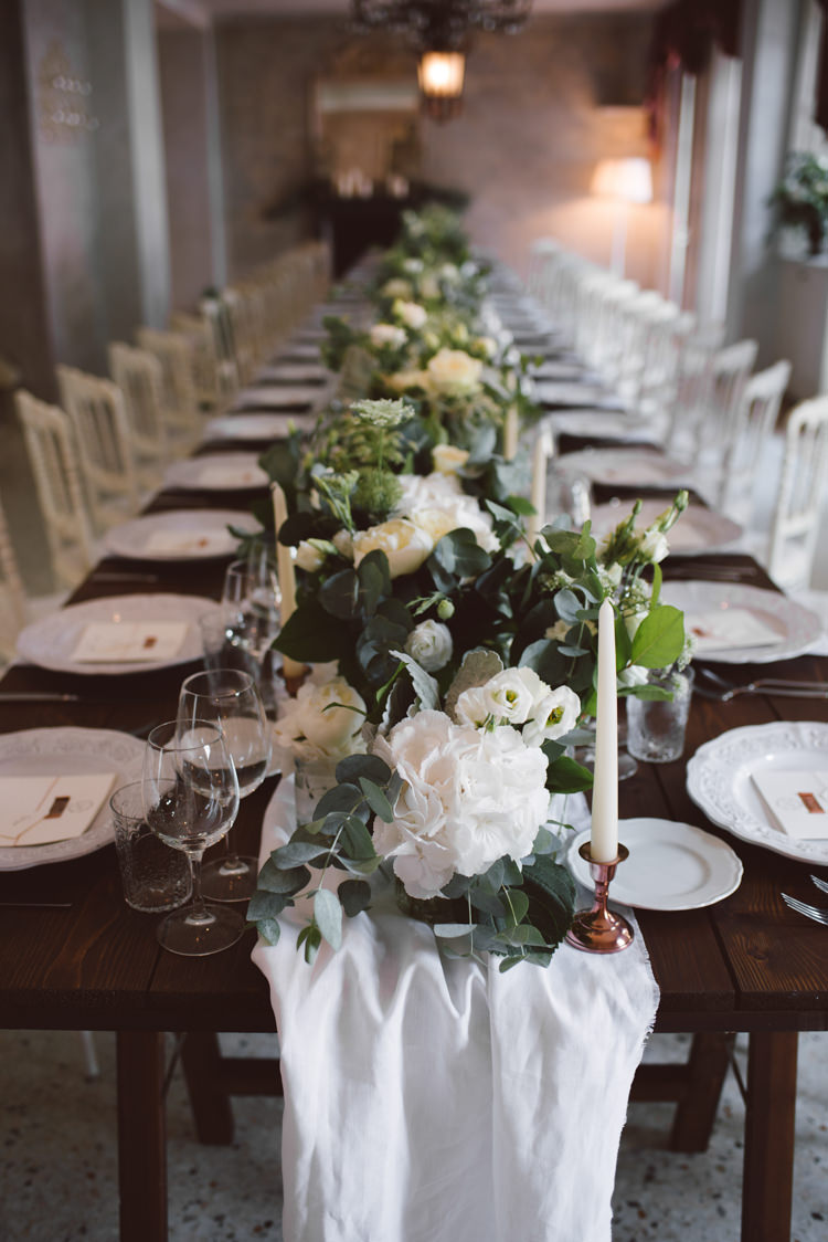 Reception Long Wooden Table White Chairs White Florals Greenery Copper Candlesticks Patterned White China Botanical Copper Greenery Lake Como Wedding http://margheritacalatiphotography.com/