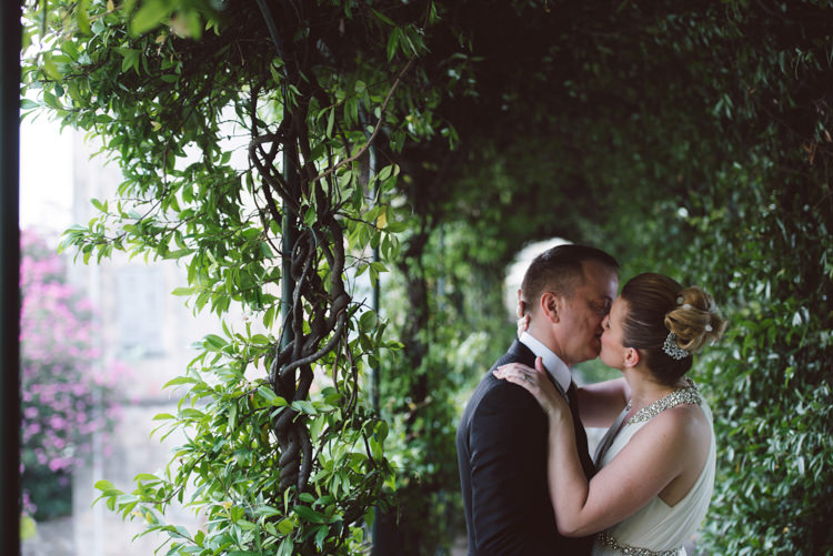 Bride V Neck Jenny Packham Embellished Bridal Gown Crystal Hairpiece Groom Tailored Black Suit White Shirt Black Tie Botanical Copper Greenery Lake Como Wedding http://margheritacalatiphotography.com/