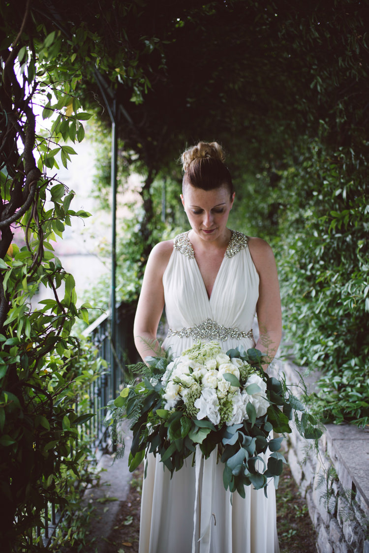 Bride V Neck Jenny Packham Embellished Bridal Gown Bouquet White Florals Roses Greenery Eucalyptus Bun Hairstyle Botanical Copper Greenery Lake Como Wedding http://margheritacalatiphotography.com/