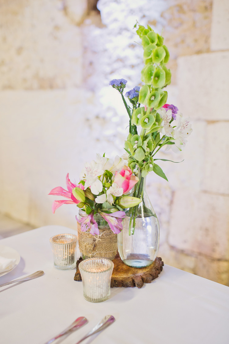 Table Decoration Bottle Flowers Hessian Twine Wood Slice Votive Candle Colour Pop Summer French Chateau Wedding http://www.cottoncandyweddings.co.uk/