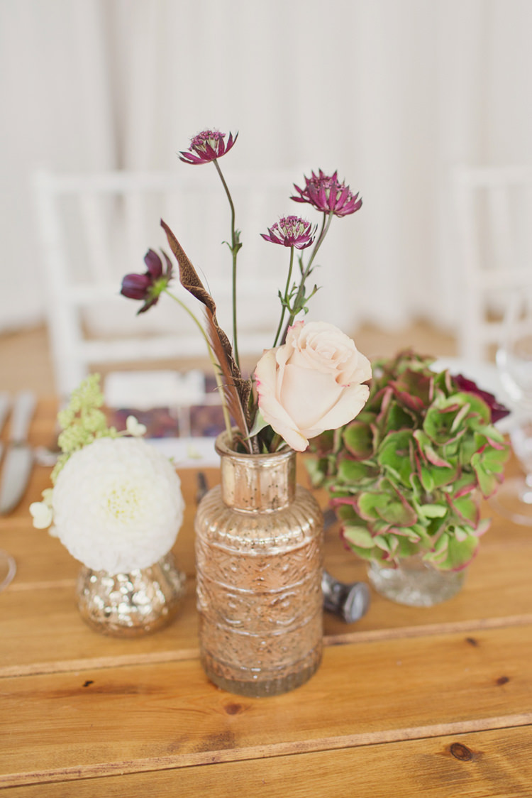 Bottle Flowers Decor Antler Feather Stunning Countryside Wedding http://www.cottoncandyweddings.co.uk/