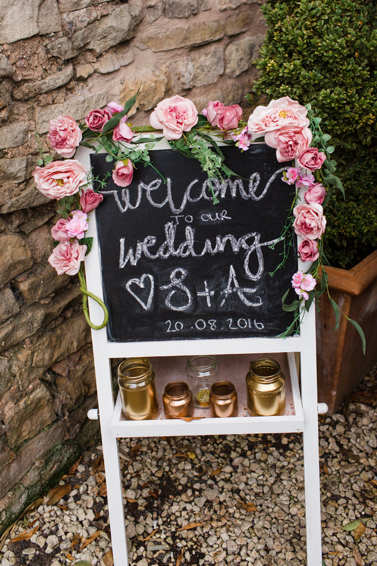 Chalkboard Sign Gold Jars Flowers Roses Burgundy Gold Rustic Glam Barn Wedding http://www.terripashleyphotography.co.uk/