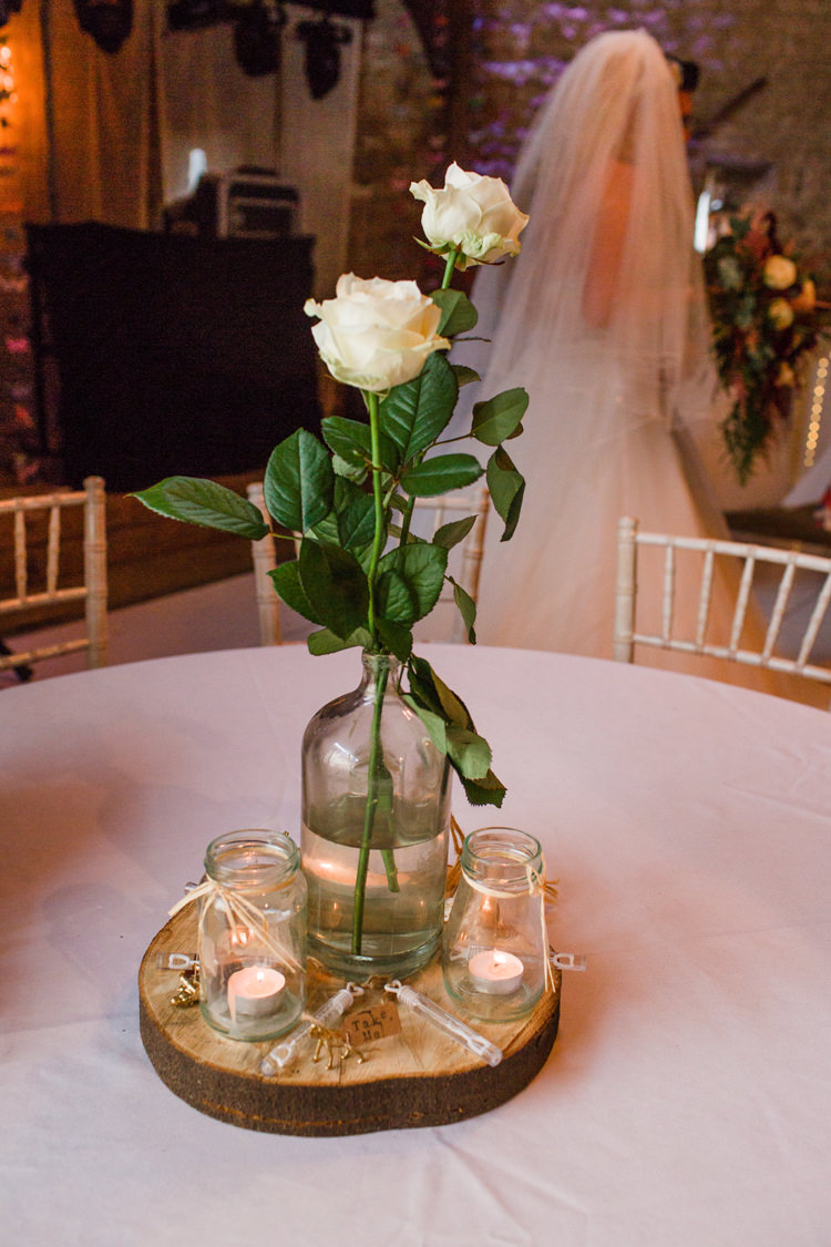 Table Centre Bottle Jars White Roses Wood Slice Bubbles Tealights Burgundy Gold Rustic Glam Barn Wedding http://www.terripashleyphotography.co.uk/