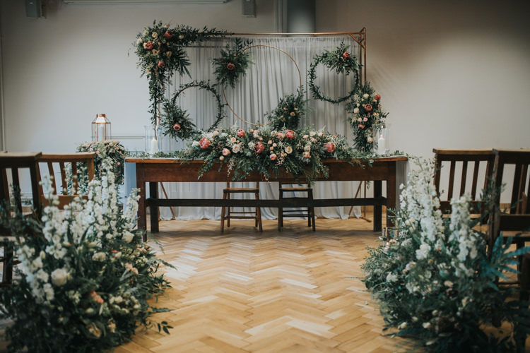 Ceremony Flowers Backdrop Hoops Foliage Aisle Pew End Chairs Table Industrial Into The Wild Greenery Wedding Ideas http://www.ivoryfayre.com/
