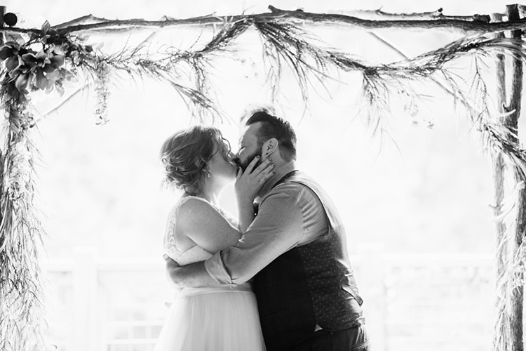 Indoor Barn Ceremony Bride Lace Tulle Bridal Gown Groom Light Grey Shirt Custom Vest Floral Arch The Kiss Creative Quirky Rustic Barn Wedding Tennessee http://www.alexbeephoto.com/