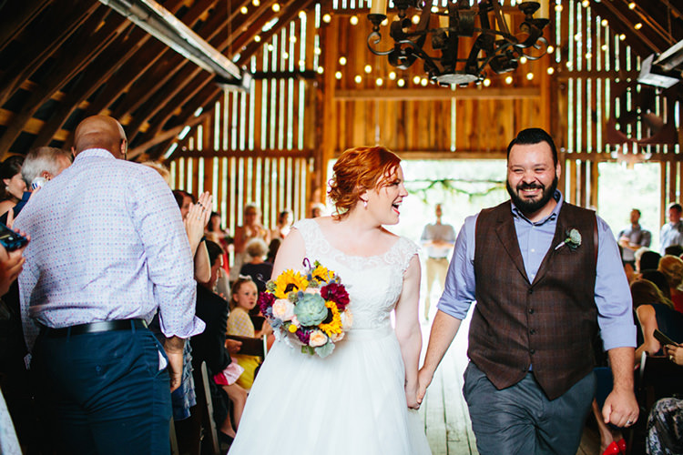 Indoor Barn Ceremony Just Married Bride Lace Tulle Bridal Gown Multicoloured Bouquet Groom Dark Grey Pants Light Grey Shirt Custom Vest Guests Fairy Lights Creative Quirky Rustic Barn Wedding Tennessee http://www.alexbeephoto.com/