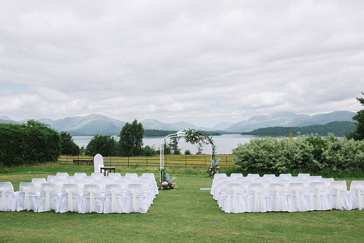 Ceremony White Chair Covers Archway Hydrangeas Pink Blue Greenery Scenic Outdoor Loch Lomond Wedding http://www.lisadevinephotography.co.uk/