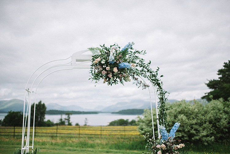 Ceremony Arch Backdrop Pink Blue Floral Flowers Greenery Scenic Outdoor Loch Lomond Wedding http://www.lisadevinephotography.co.uk/