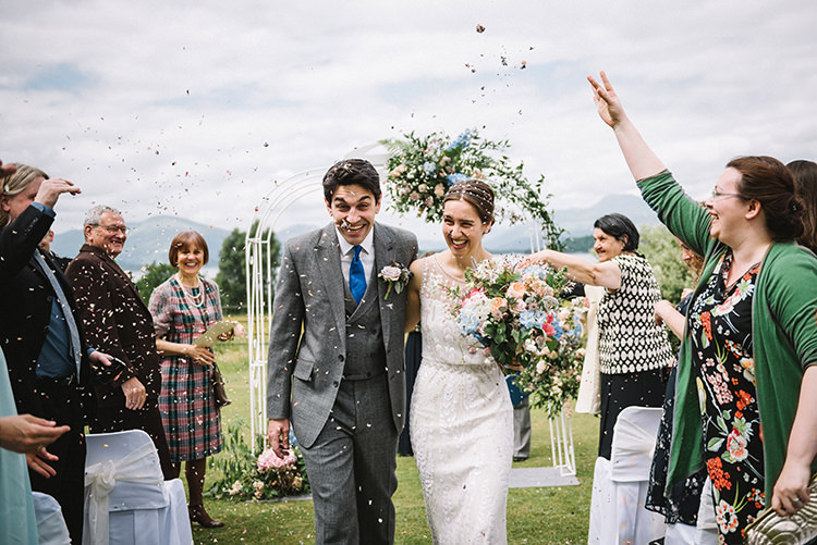 Confetti Shot Ceremony Kiss Jenny Packham Bride Bridal Steven Purvis Bespoke Groom Prince of Wales Check Archway Pink Blue Stocks Hydrangeas Greenery Bouquet Scenic Outdoor Loch Lomond Wedding http://www.lisadevinephotography.co.uk/